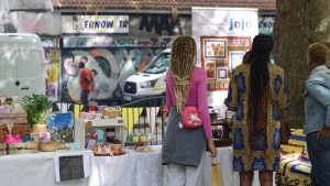 Two women with their backs to the camera looking at a stall in the pack